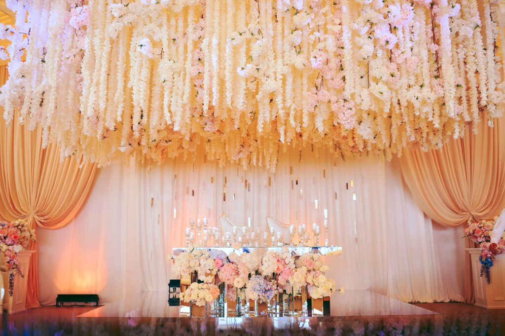 groom and bride's wedding table decorated with tender flowers and whitecandles